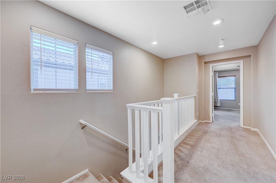645 Monument Point Street Henderson, NV 89002 - Photo 26 of 54 Corridor with an upstairs landing, light carpet, and recessed lighting