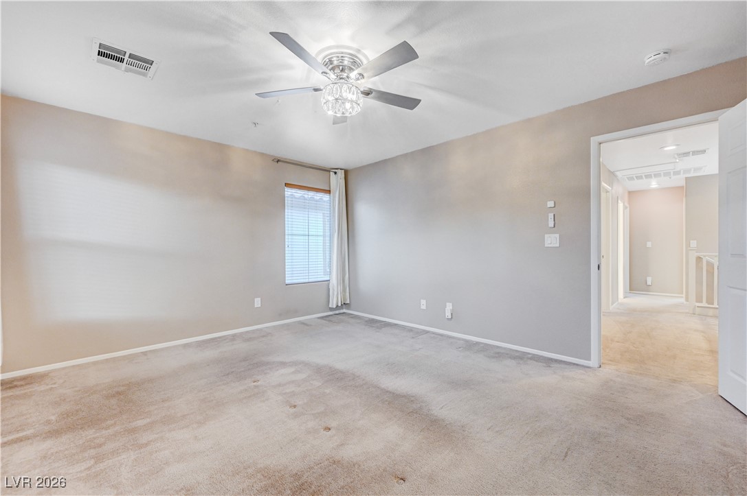 645 Monument Point Street Henderson, NV 89002 - Photo 29 of 54 Unfurnished room featuring light colored carpet and a ceiling fan