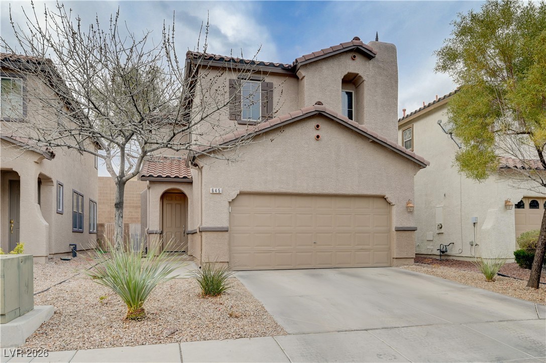 645 Monument Point Street Henderson, NV 89002 - Photo 3 of 54 Mediterranean / spanish-style home with stucco siding, a tile roof, and driveway