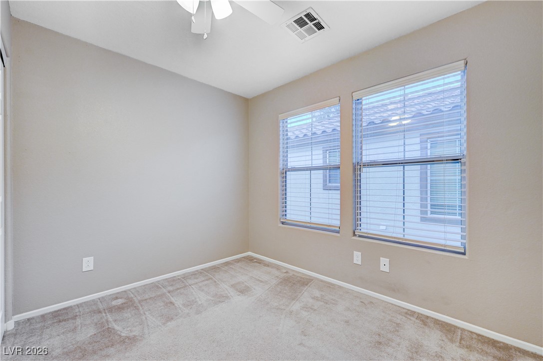 645 Monument Point Street Henderson, NV 89002 - Photo 35 of 54 Spare room with light carpet and ceiling fan