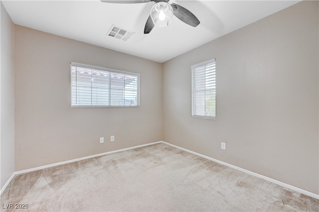 645 Monument Point Street Henderson, NV 89002 - Photo 40 of 54 Carpeted spare room with baseboards and a ceiling fan