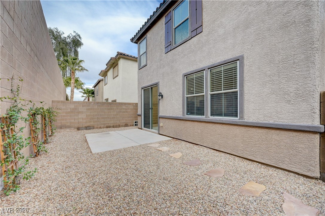 645 Monument Point Street Henderson, NV 89002 - Photo 46 of 54 Rear view of house with a patio area, a fenced backyard, stucco siding, and a tiled roof