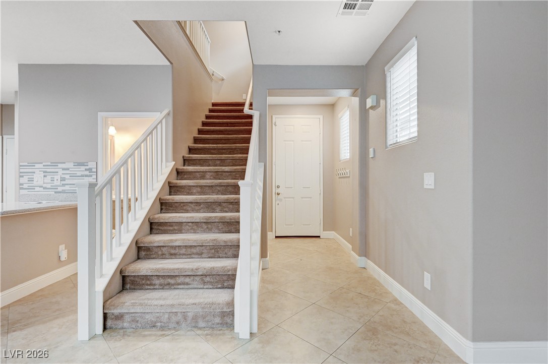 645 Monument Point Street Henderson, NV 89002 - Photo 6 of 54 Stairs featuring tile patterned flooring and baseboards