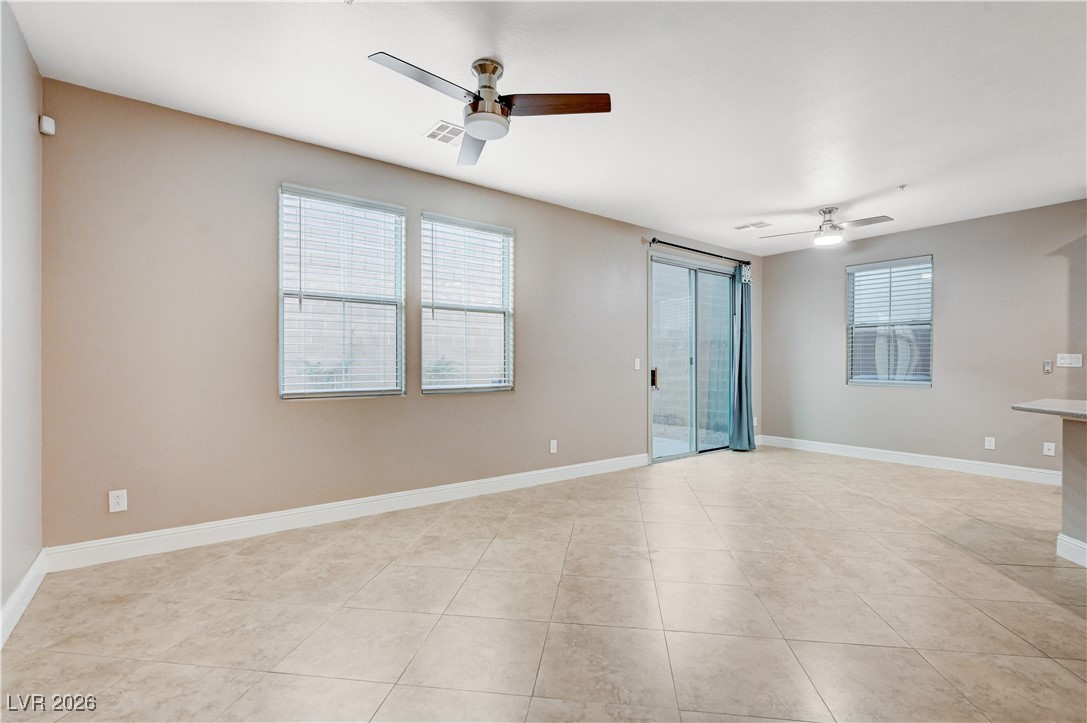 645 Monument Point Street Henderson, NV 89002 - Photo 7 of 54 Unfurnished room with a ceiling fan and light tile patterned floors