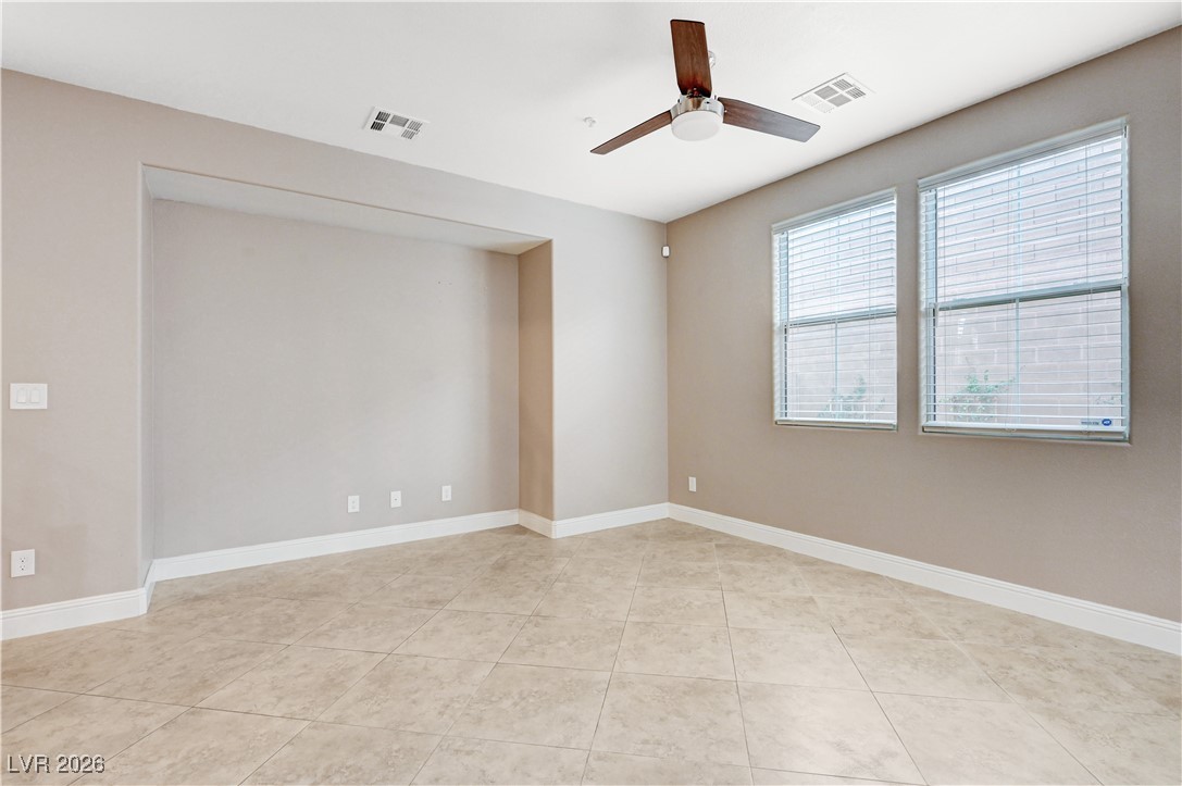 645 Monument Point Street Henderson, NV 89002 - Photo 9 of 54 Empty room featuring ceiling fan and light tile patterned flooring