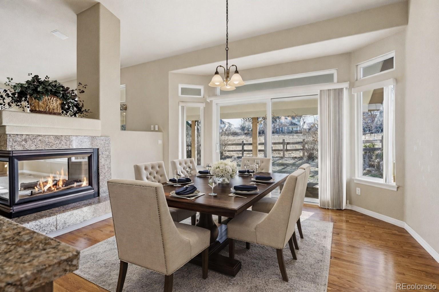 10482 Grizzly Gulch Highlands Ranch, CO 80129 - Photo 16 of 50 a dining room with furniture window and wooden floor