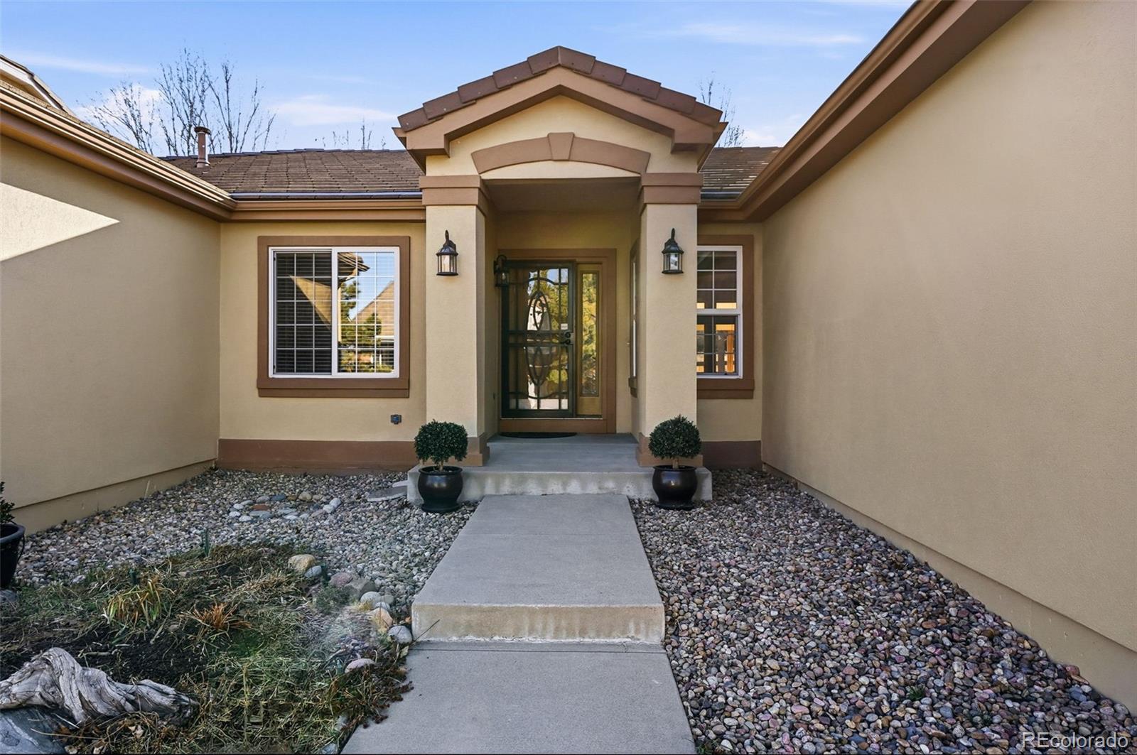 10482 Grizzly Gulch Highlands Ranch, CO 80129 - Photo 2 of 50 a front view of a house with garden