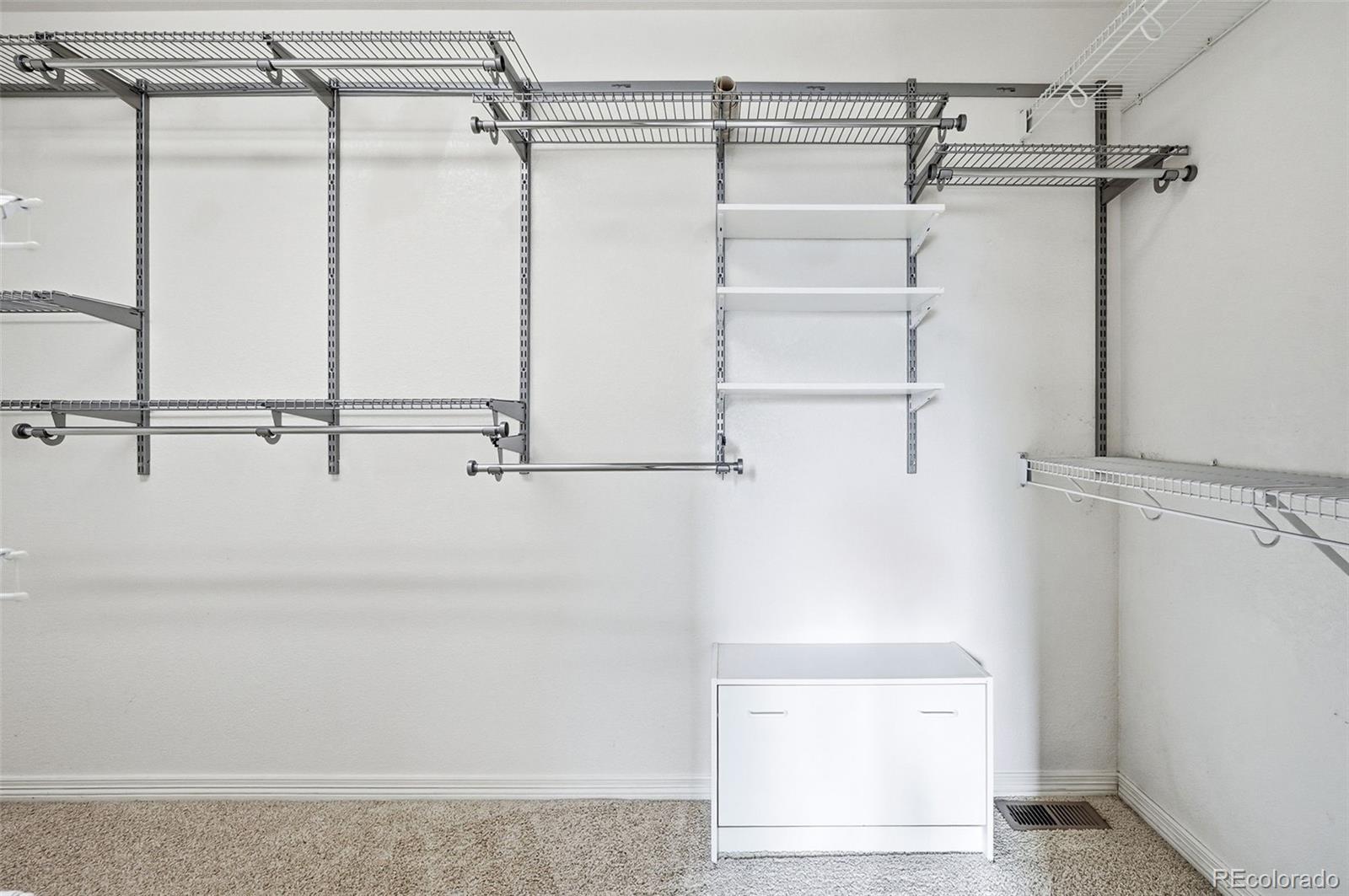 10482 Grizzly Gulch Highlands Ranch, CO 80129 - Photo 32 of 50 a view of walk in closet with empty racks