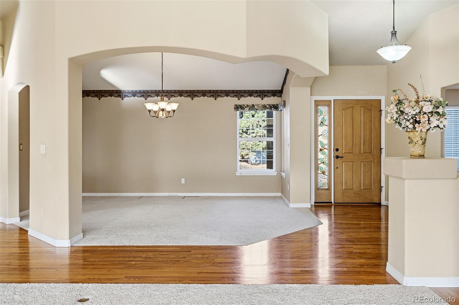 10482 Grizzly Gulch Highlands Ranch, CO 80129 - Photo 5 of 50 a view of a livingroom with a window and wooden floor