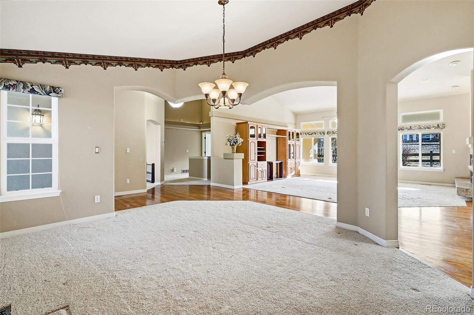 10482 Grizzly Gulch Highlands Ranch, CO 80129 - Photo 6 of 50 a view of a room with a chandelier and living room