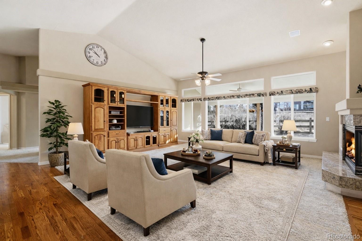 10482 Grizzly Gulch Highlands Ranch, CO 80129 - Photo 8 of 50 a living room with furniture wooden floor and a chandelier