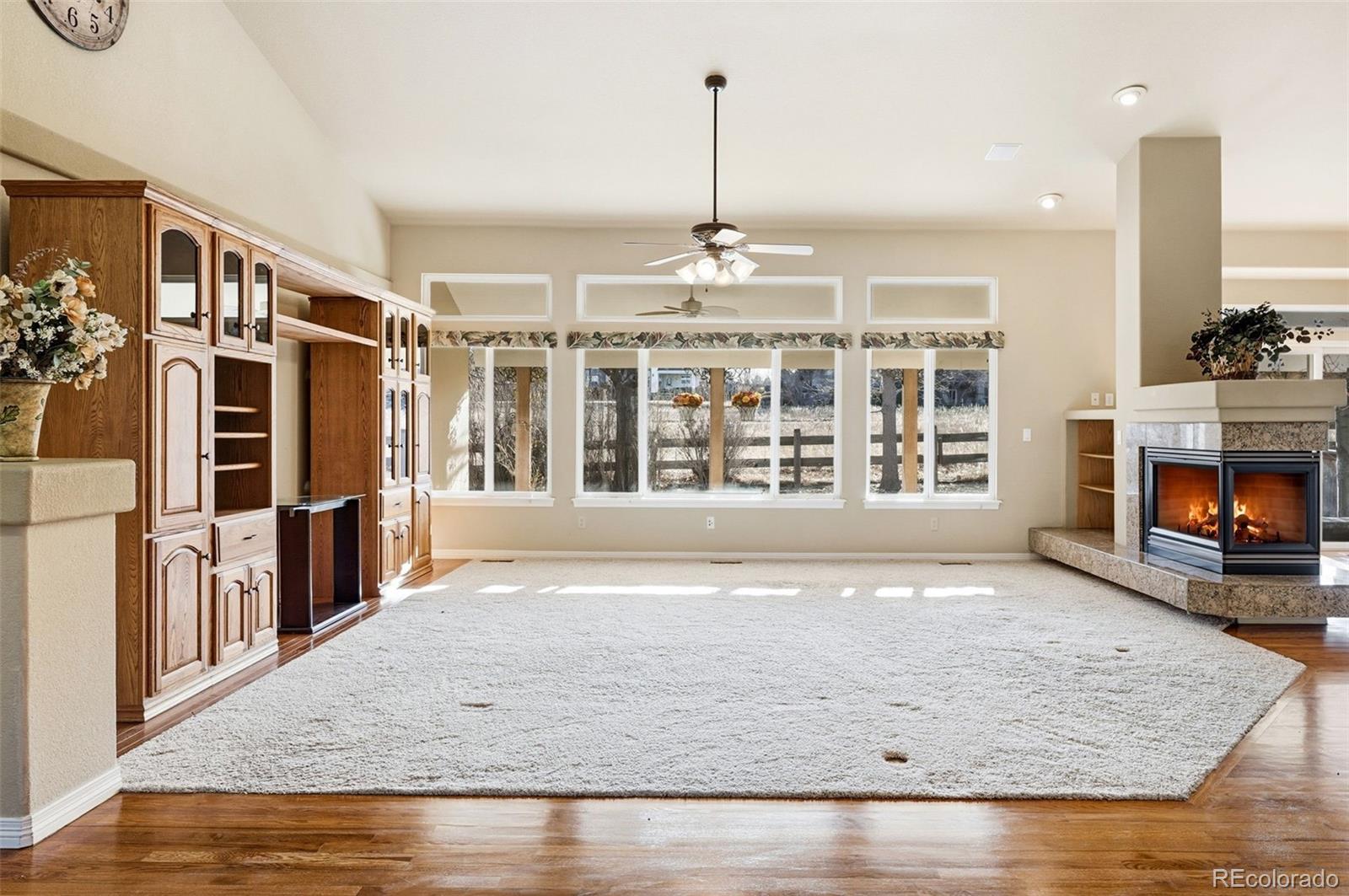 10482 Grizzly Gulch Highlands Ranch, CO 80129 - Photo 9 of 50 a view of an empty room with wooden floor and a window