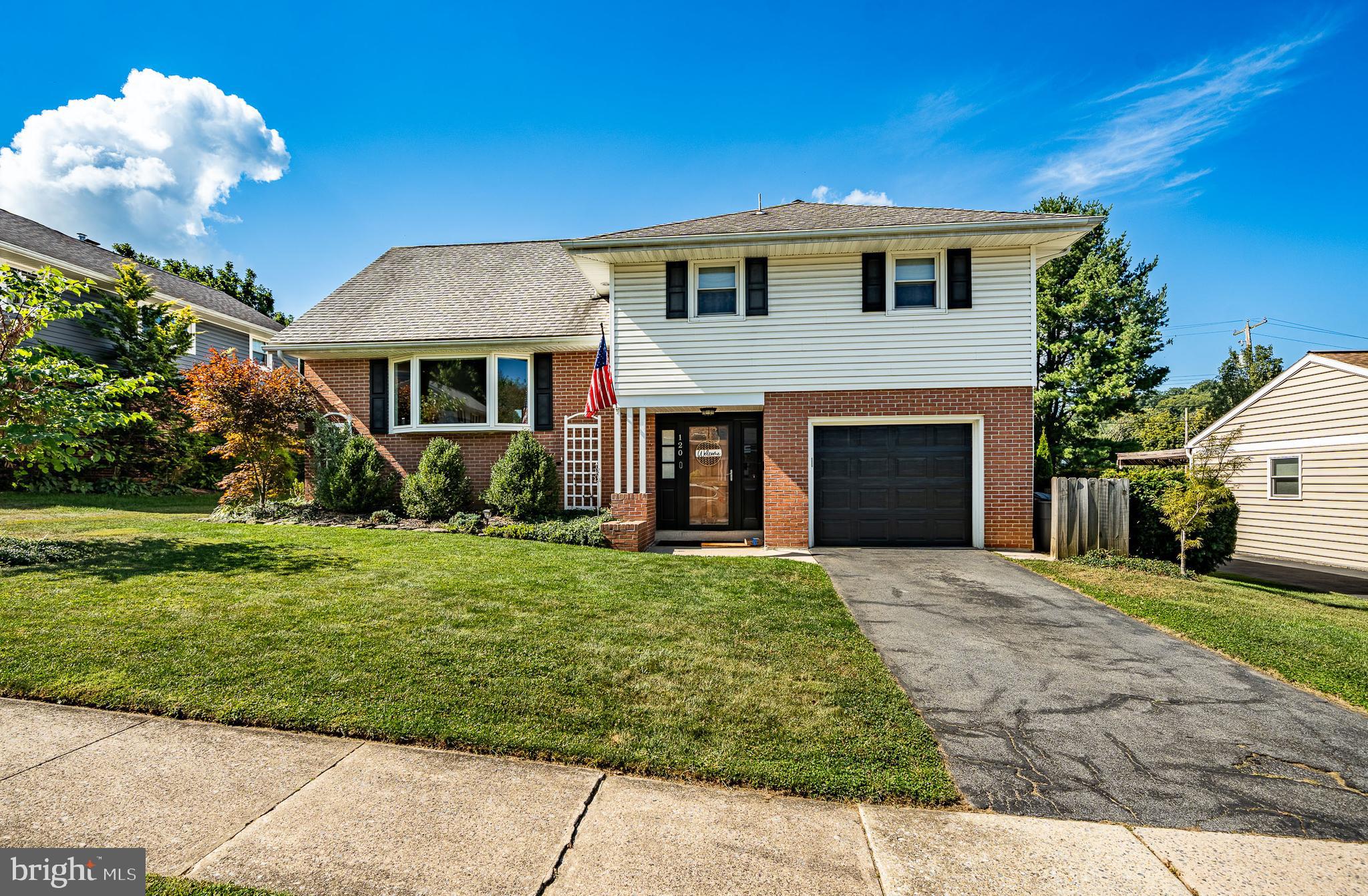 120 Kerrick Road Reading, PA 19607 - Photo 1 of 32 a front view of a house with a yard and garage
