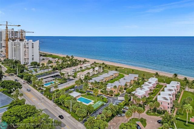 an aerial view of residential houses with city view