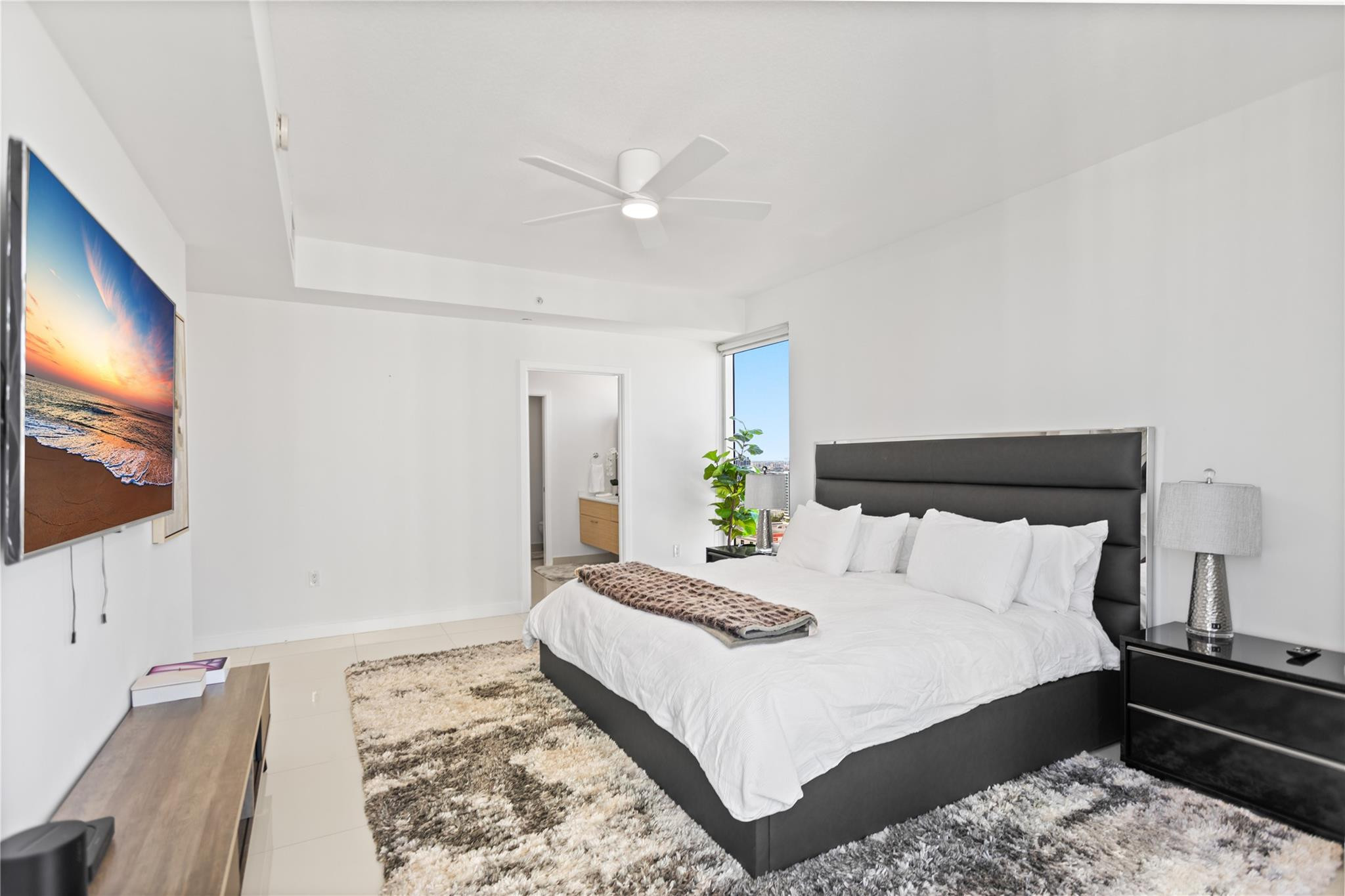 600 Northeast 27th Street, Unit 2301 Miami, FL 33137 - Photo 17 of 77 a bedroom with a bed and a flat screen tv