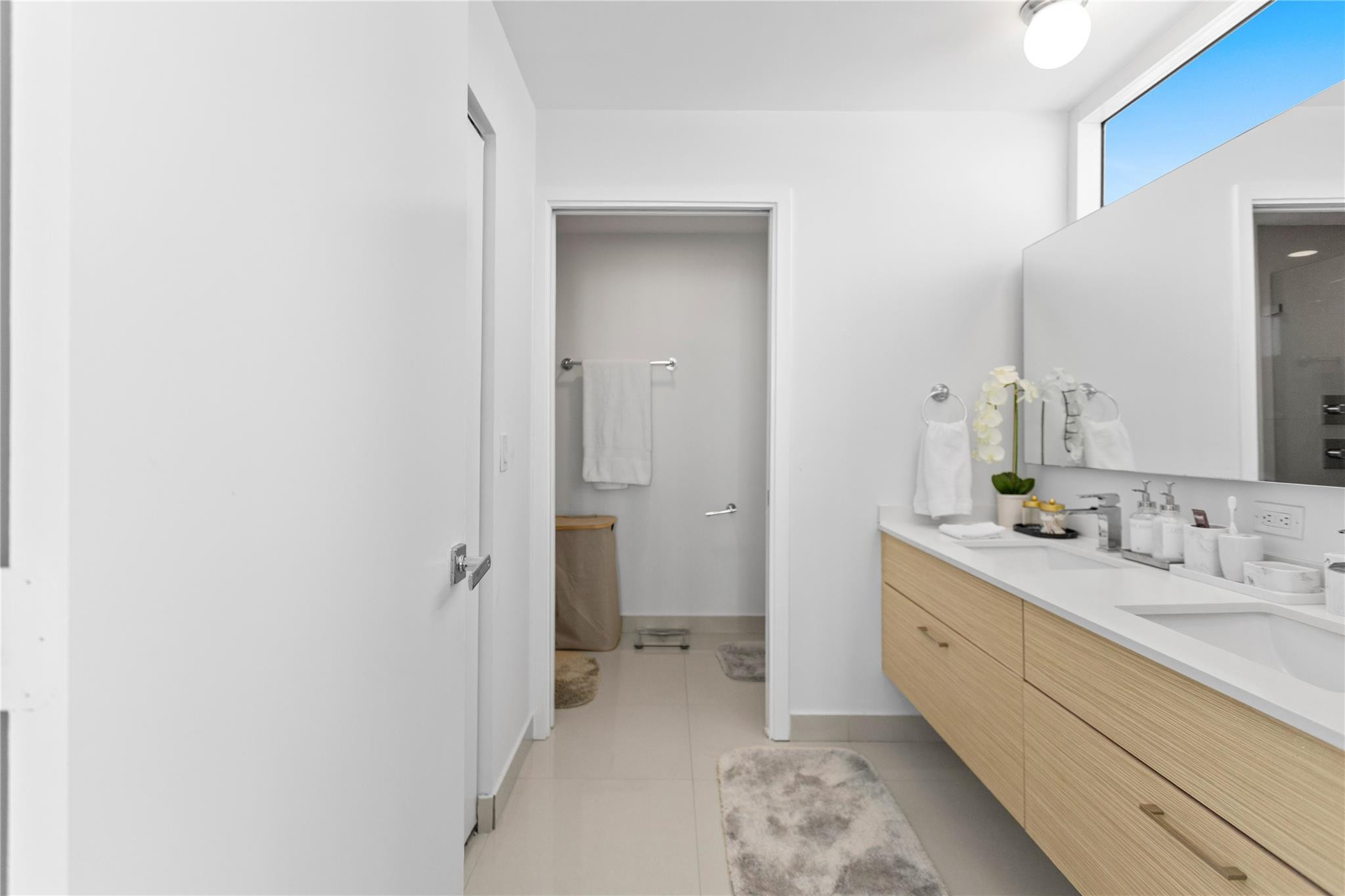 600 Northeast 27th Street, Unit 2301 Miami, FL 33137 - Photo 33 of 77 a bathroom with a double vanity sink and mirror
