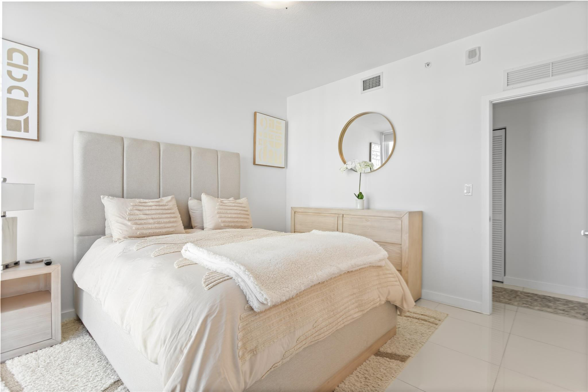 600 Northeast 27th Street, Unit 2301 Miami, FL 33137 - Photo 42 of 77 a bedroom with a bed a mirror and a window