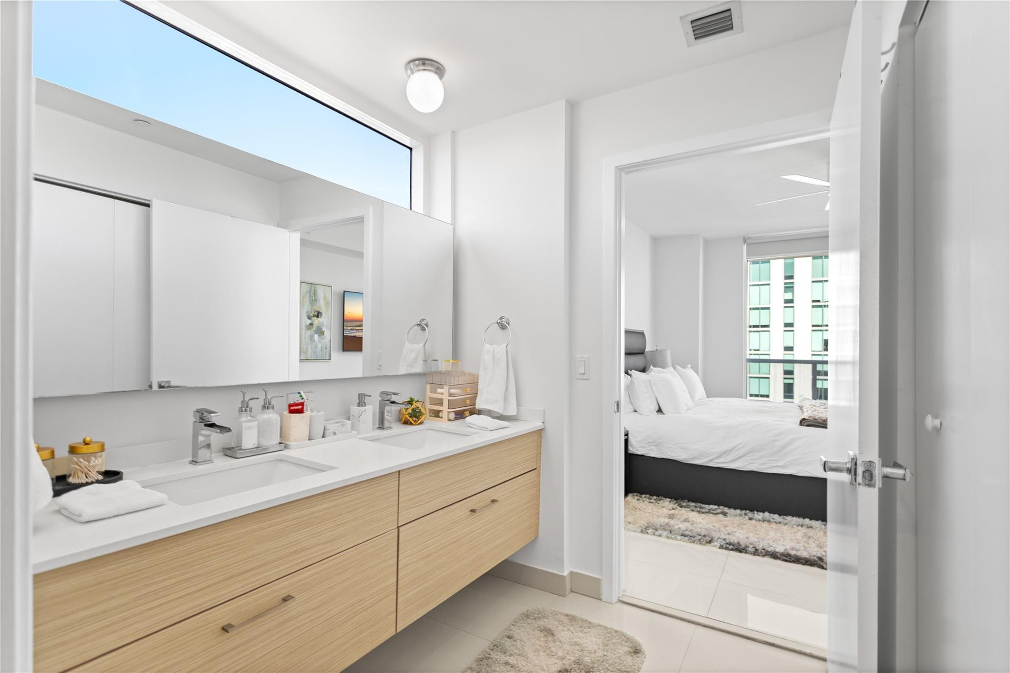 600 Northeast 27th Street, Unit 2301 Miami, FL 33137 - Photo 43 of 77 a en suite bathroom with a double vanity sink and mirror