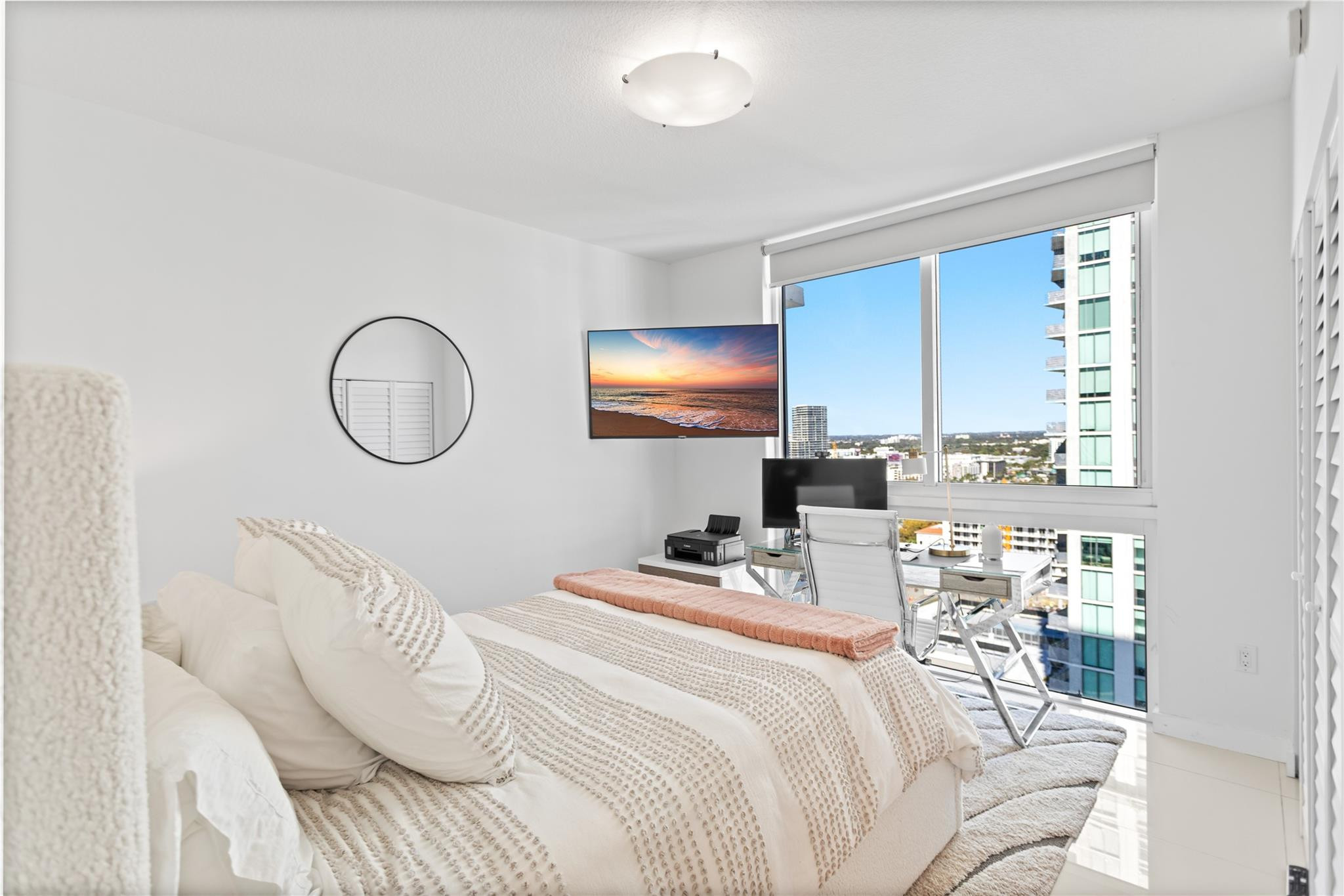 600 Northeast 27th Street, Unit 2301 Miami, FL 33137 - Photo 50 of 77 a bedroom with a bed a mirror and a window