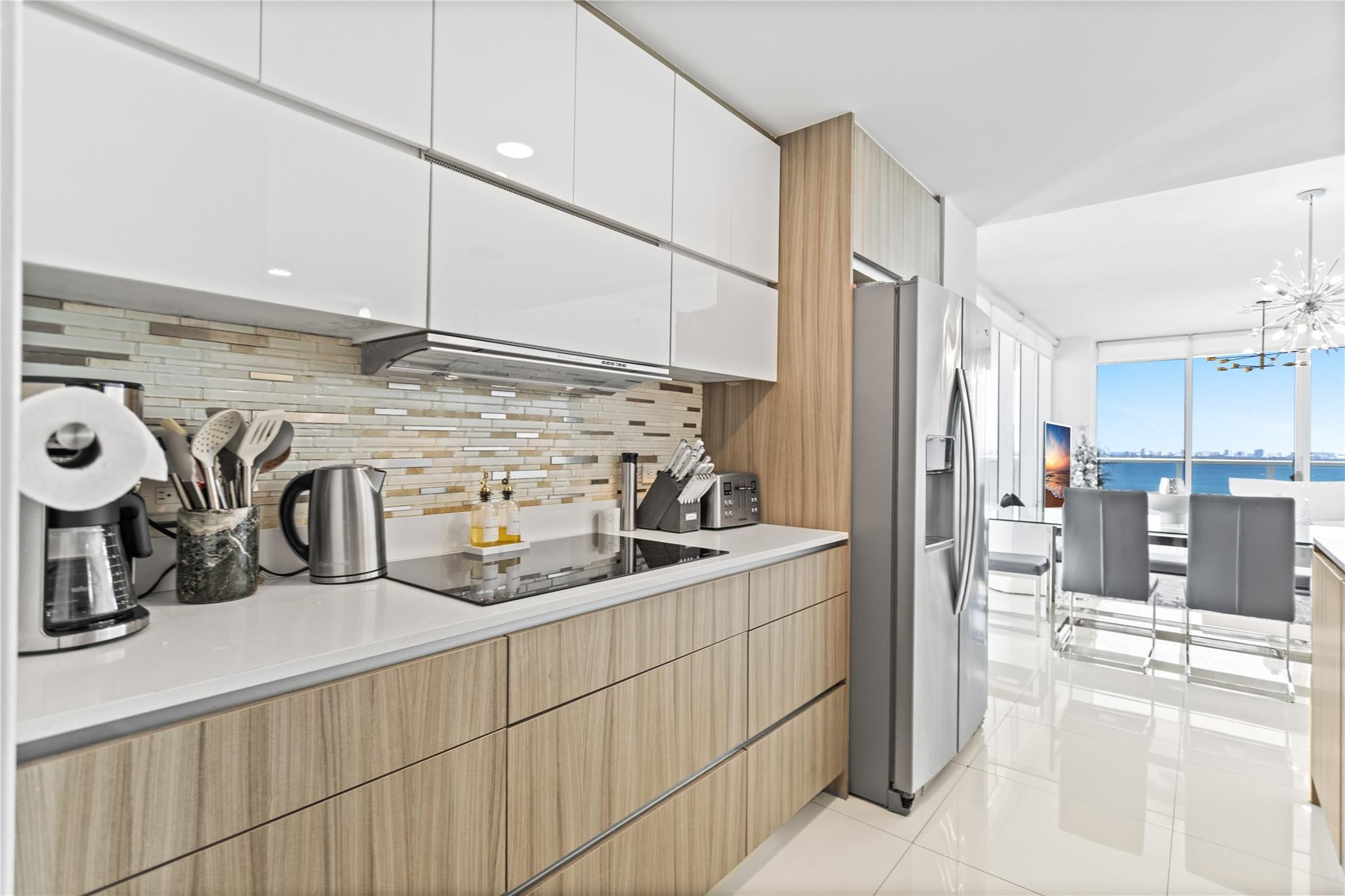 600 Northeast 27th Street, Unit 2301 Miami, FL 33137 - Photo 5 of 77 a kitchen with stainless steel appliances kitchen island granite countertop a sink and a refrigerator