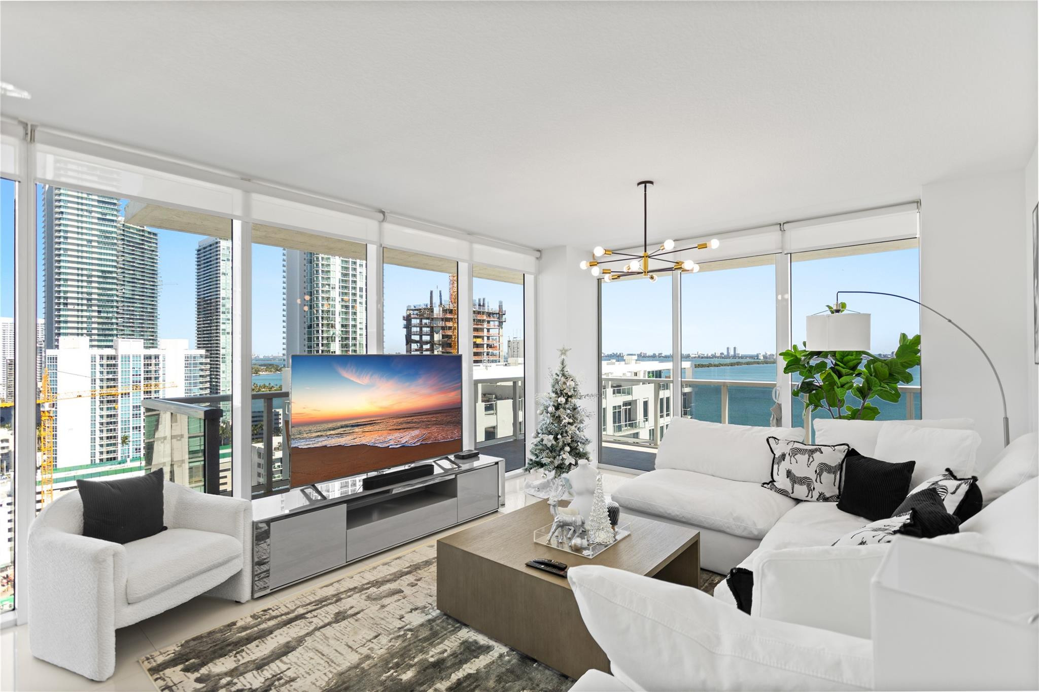 600 Northeast 27th Street, Unit 2301 Miami, FL 33137 - Photo 51 of 77 a living room with furniture and a flat screen tv