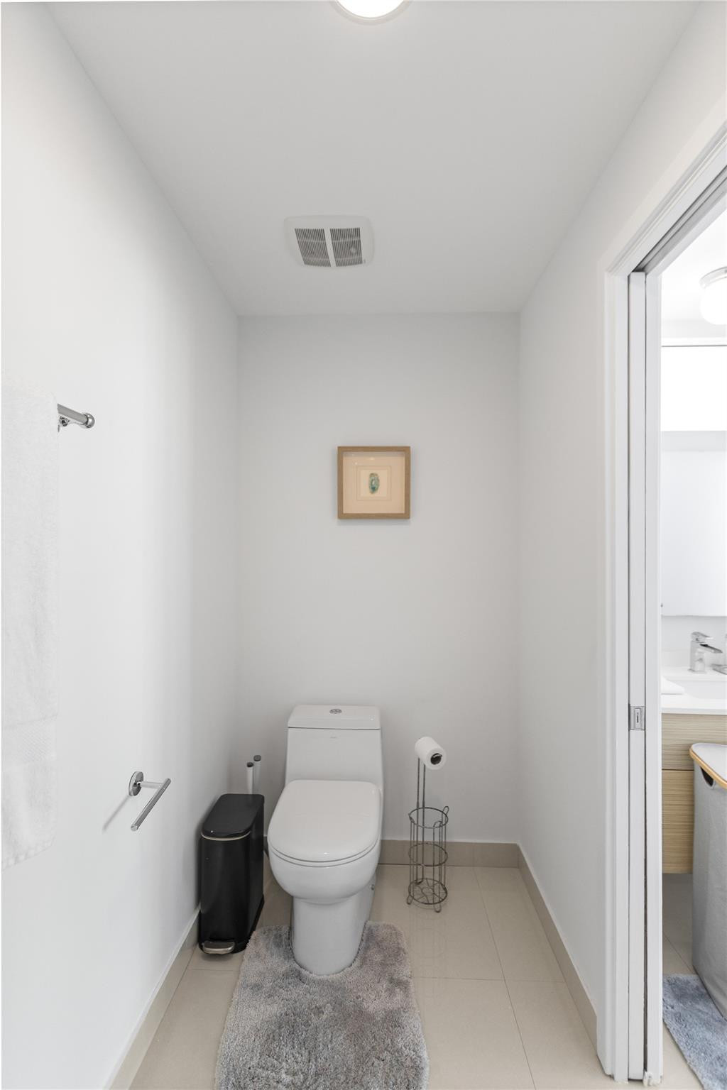 600 Northeast 27th Street, Unit 2301 Miami, FL 33137 - Photo 67 of 77 a white toilet sitting next to a bathroom sink