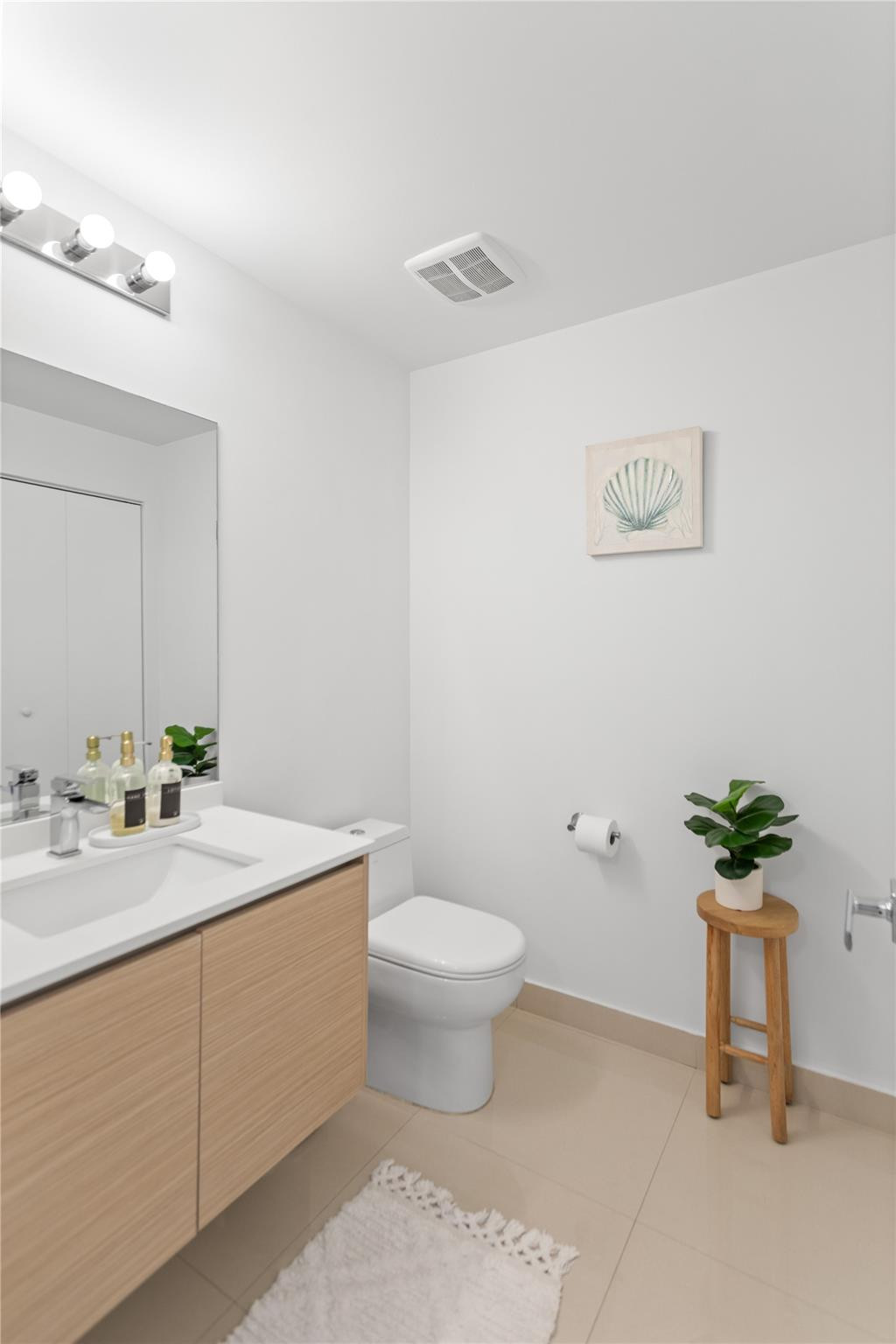 600 Northeast 27th Street, Unit 2301 Miami, FL 33137 - Photo 9 of 77 a bathroom with a sink toilet and a mirror