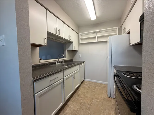 a kitchen with stainless steel appliances a stove and a refrigerator