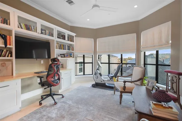 a view of a livingroom with workspace and windows