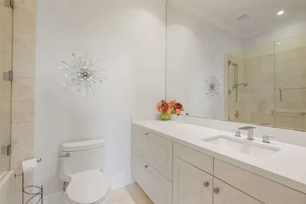a bathroom with a sink vanity and toilet