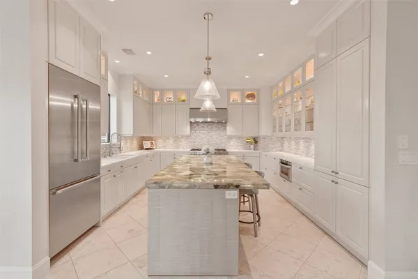 a kitchen with a sink stainless steel appliances and cabinets