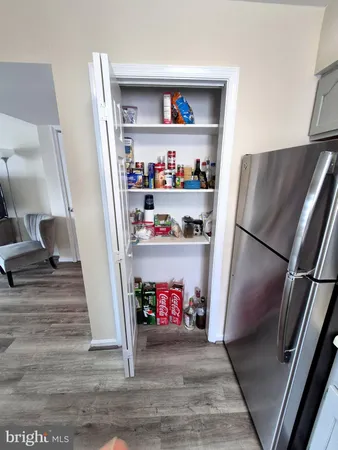 a view of kitchen with refrigerator and wooden floor
