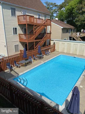 a view of a balcony with table and chairs