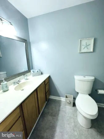 a bathroom with a sink toilet and mirror