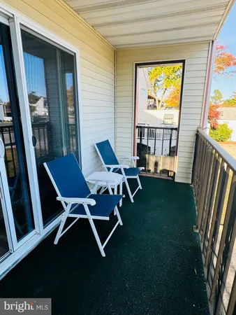 a living room with chairs and a table