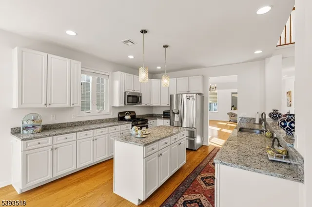 a kitchen with a sink stove and refrigerator