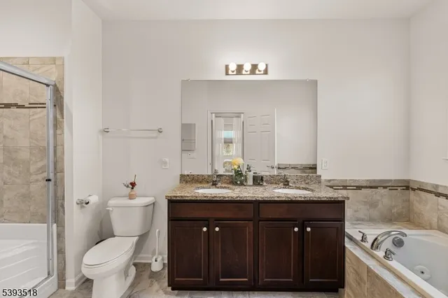 a bathroom with a sink vanity mirror and toilet