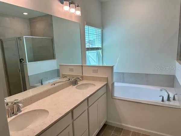 a bathroom with a bathtub and a shower