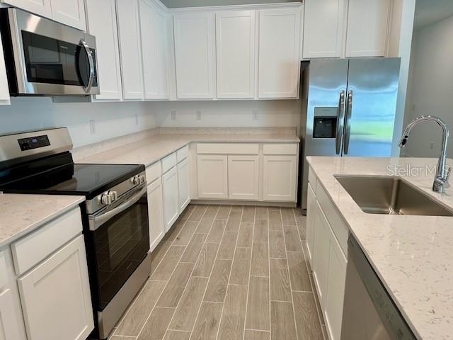 4511 Northwest 14th Loop Ocala, FL 34482 - Photo 4 of 27 a kitchen with a sink stove and microwave