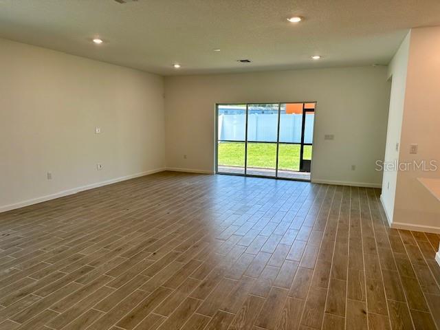 4511 Northwest 14th Loop Ocala, FL 34482 - Photo 6 of 27 an empty room with wooden floor and windows