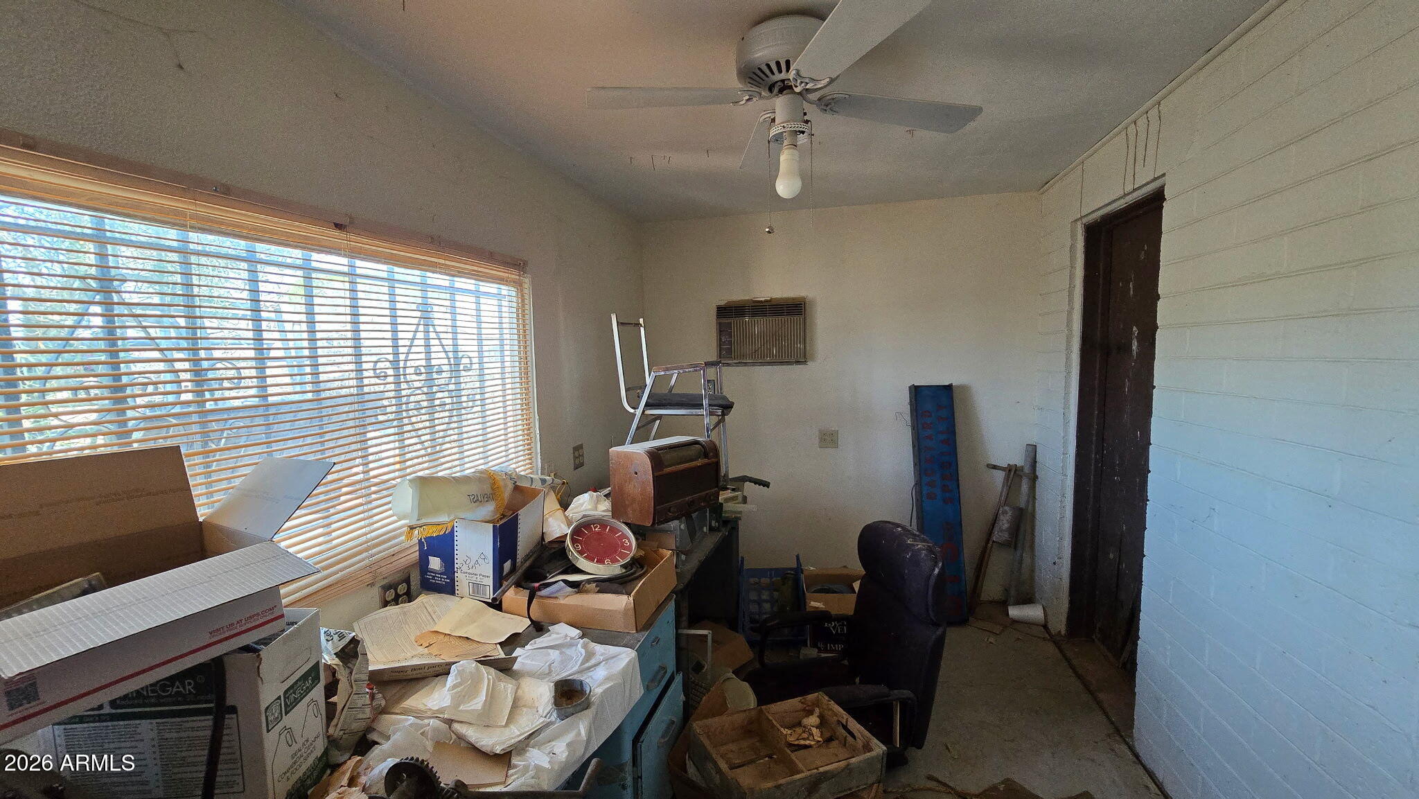 6803 South Miller Road Buckeye, AZ 85326 - Photo 21 of 50 a view of a workspace with furniture and a window