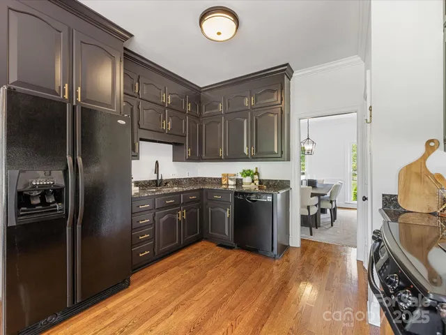 a kitchen with stainless steel appliances granite countertop a stove top oven a sink dishwasher a microwave oven and a granite counter top