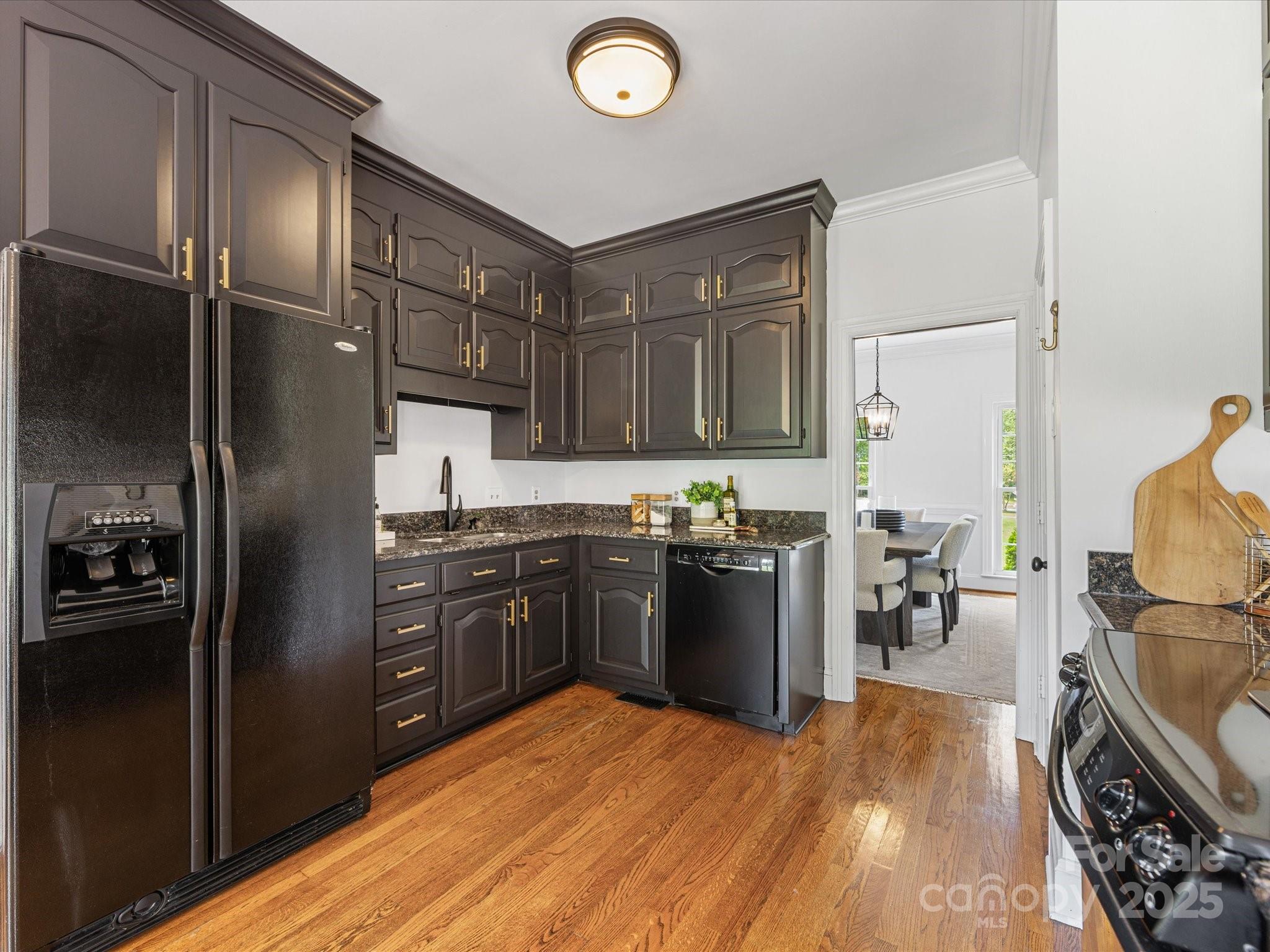 11215 Idlewild Road Matthews, NC 28105 - Photo 31 of 48 a kitchen with a refrigerator and a stove top oven