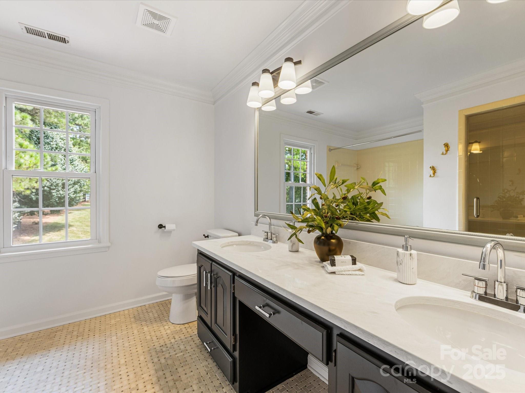 11215 Idlewild Road Matthews, NC 28105 - Photo 40 of 48 a bathroom with a sink double vanity and a mirror