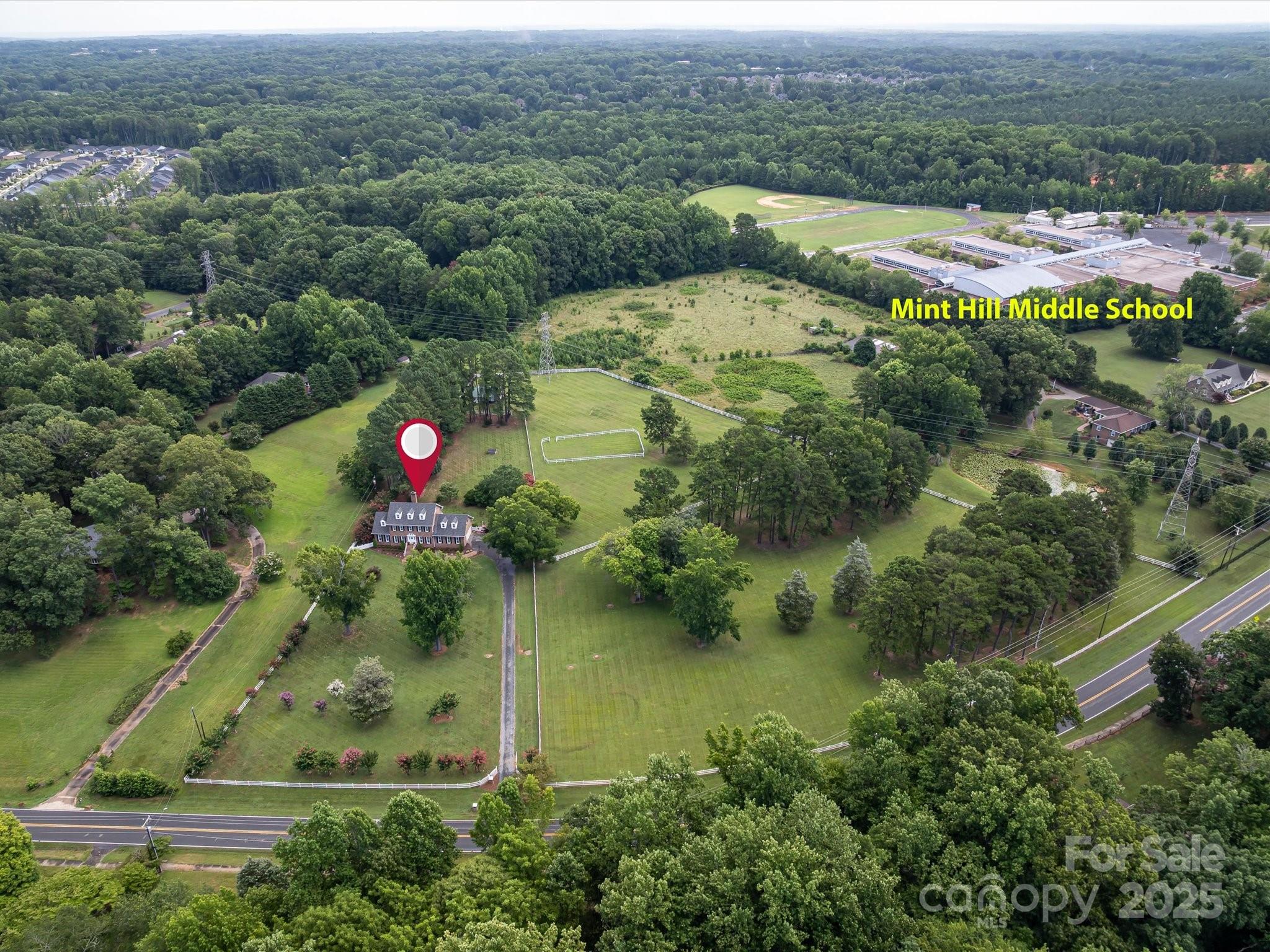 11215 Idlewild Road Matthews, NC 28105 - Photo 5 of 48 an aerial view of residential houses with outdoor space and pool