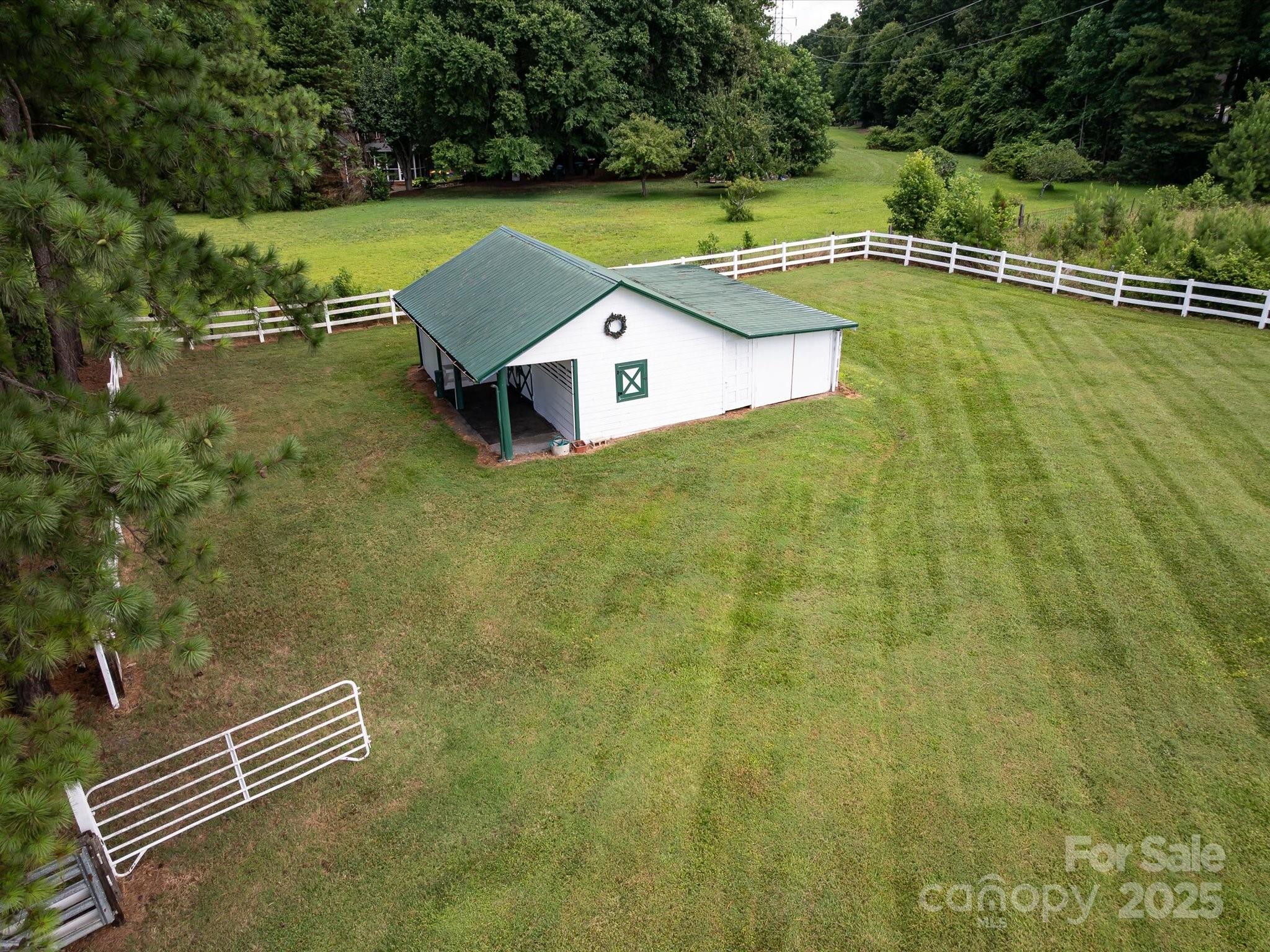 11215 Idlewild Road Matthews, NC 28105 - Photo 8 of 48 a view of a tennis ground with large trees