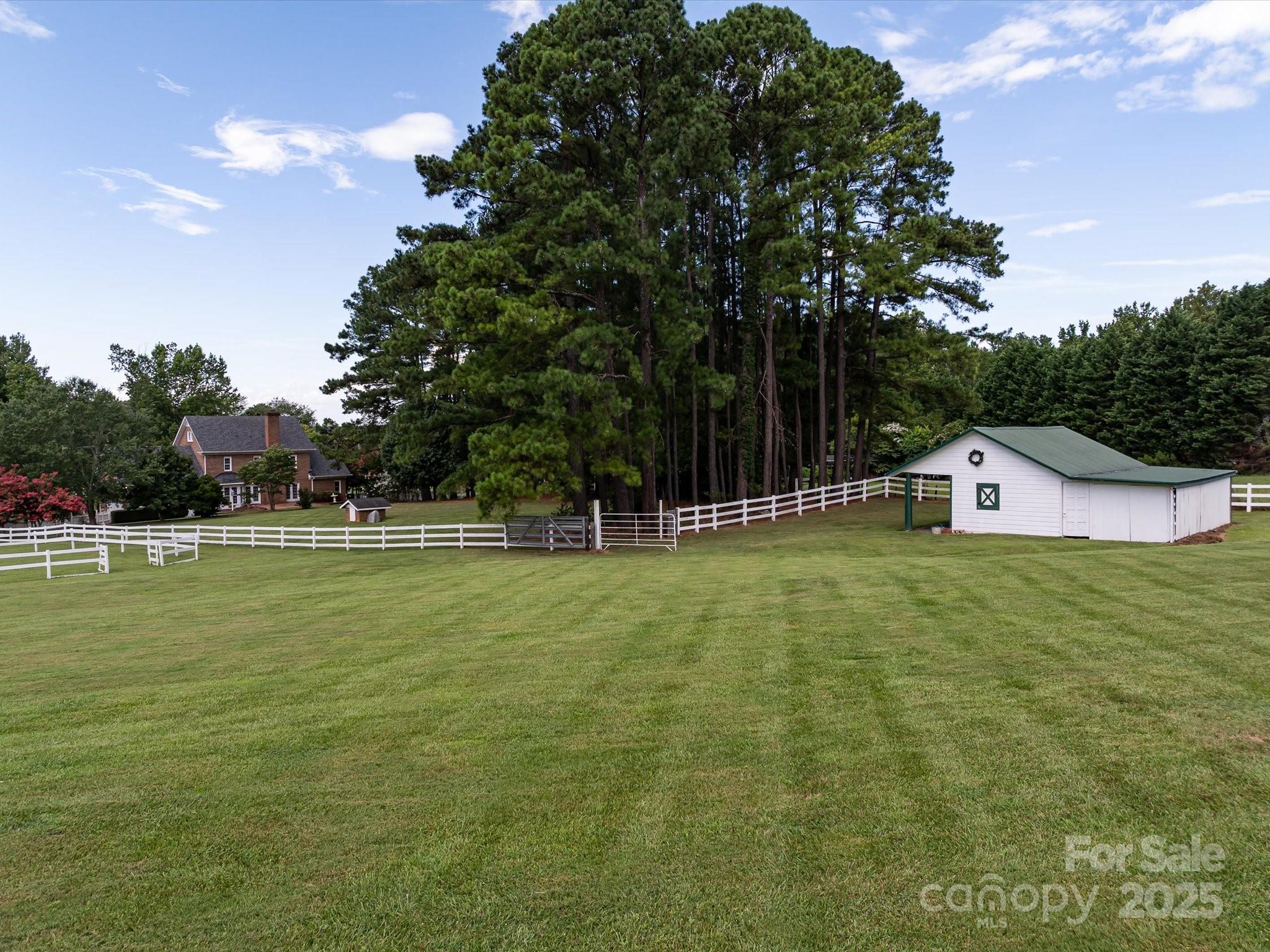 11215 Idlewild Road Matthews, NC 28105 - Photo 9 of 48 a front view of a house with a yard and trees