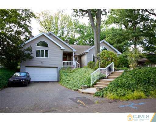 5 Beech Lane Edison, NJ 08820 - Photo 2 of 25 a front view of a house with a garden