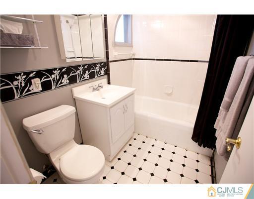 5 Beech Lane Edison, NJ 08820 - Photo 13 of 25 a bathroom with a sink toilet and shower