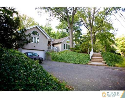 5 Beech Lane Edison, NJ 08820 - Photo 19 of 25 a front view of a house with a yard and trees